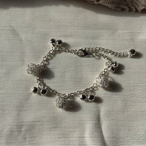 Silver tone beautiful bracelet with tiny clapper bells.